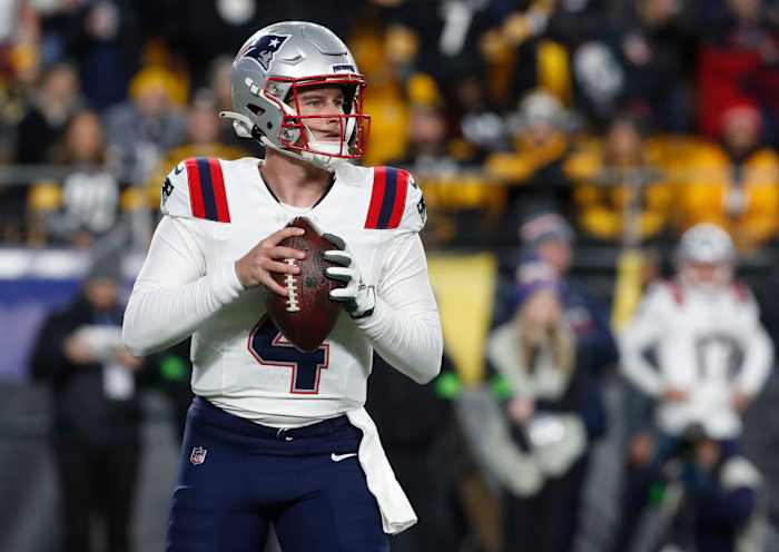 New England Patriots quarterback Bailey Zappe (4) looks to pass against the Pittsburgh Steelers during the first quarter at Acrisure Stadium.